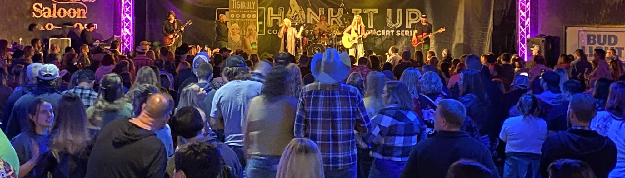 country concert with fans wearing cowboy hats Evansville